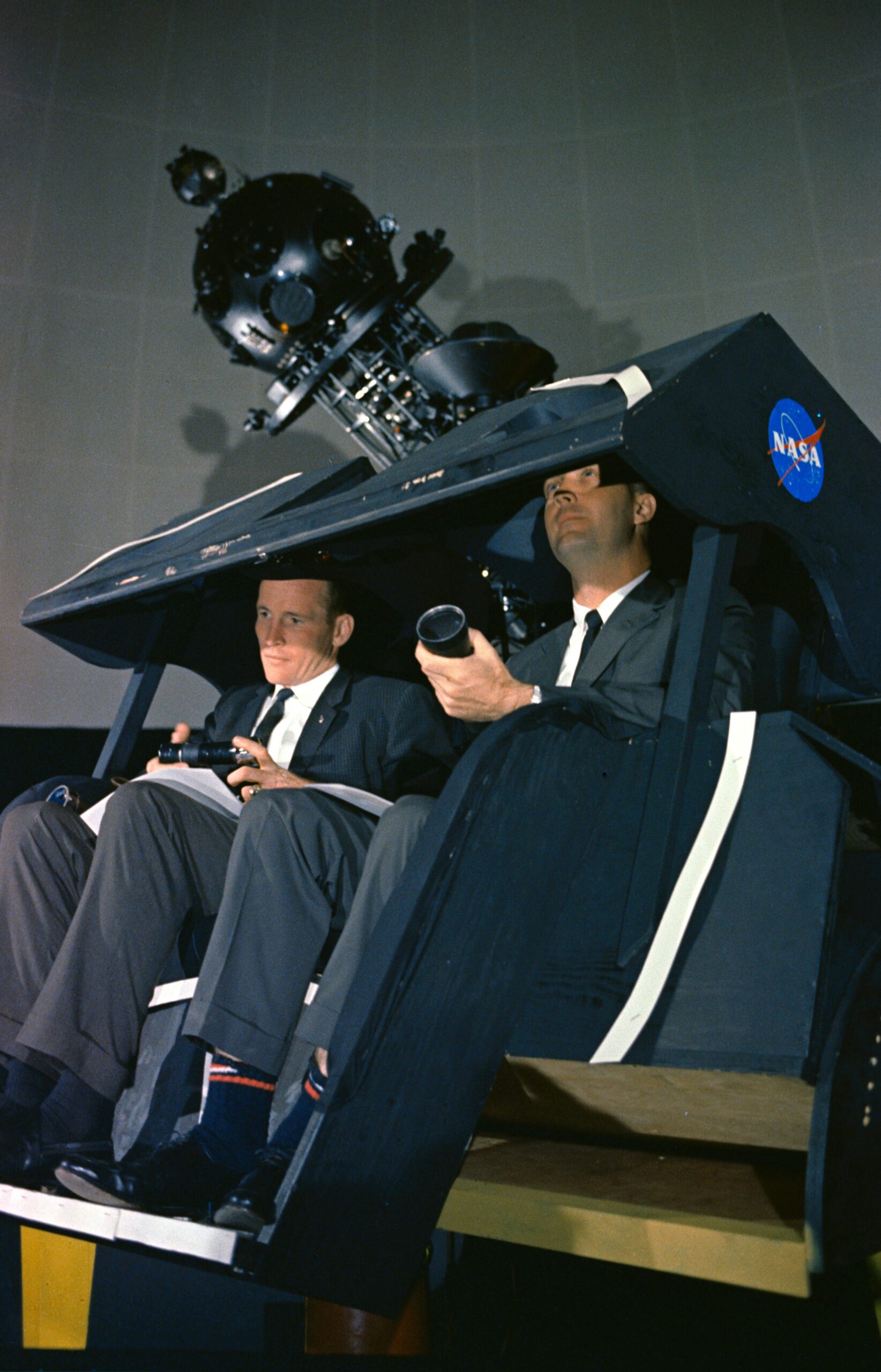 7 May 1965 --- Astronauts James A. McDivitt (right) and Edward H. White II are shown at the Morehead Planetarium in North Carolina, checking out celestial navigation equipment as part of their training for the Gemini-Titan 4 mission.